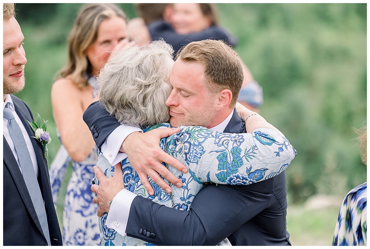 A groom hugging his new bride's grandma following their emotional Bay View wedding ceremony.