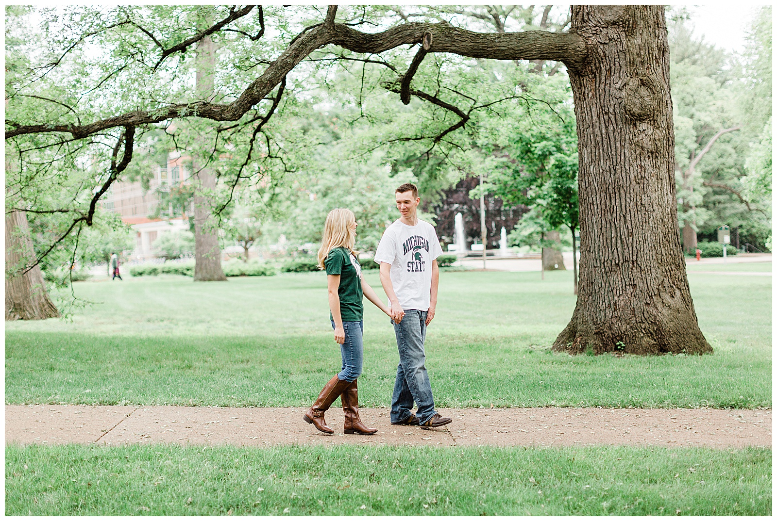 Couple walking through grounds during Michigan State University engagement session.
