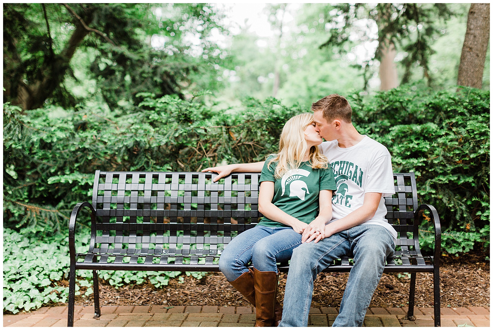 Couple kissing on bench during Michigan State University engagement session.