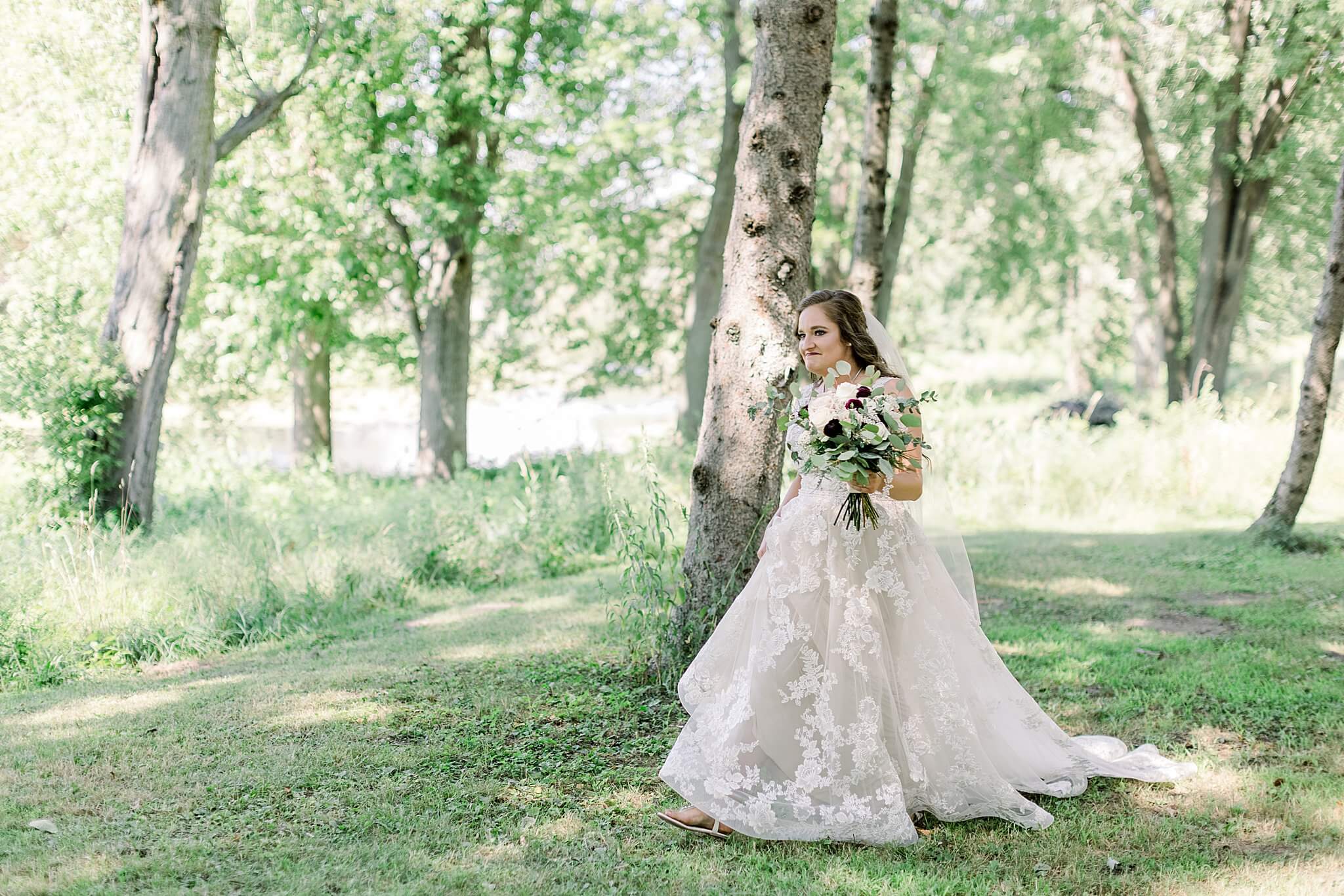 Bride cries while walking to see groom during first look at Michigan Summer Backyard Wedding.