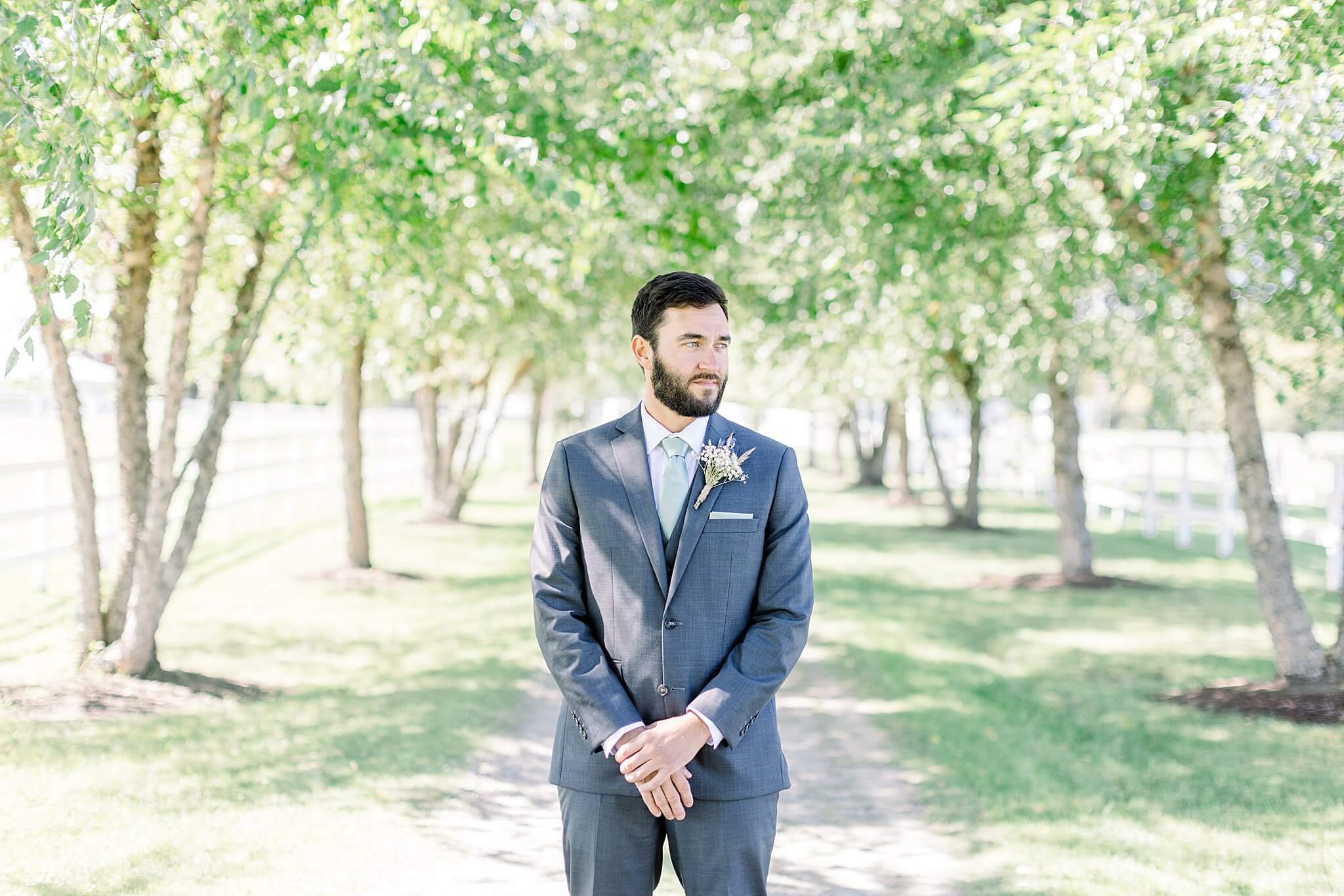 Groom waiting for bride during first look at Crooked Creek Ranch wedding.