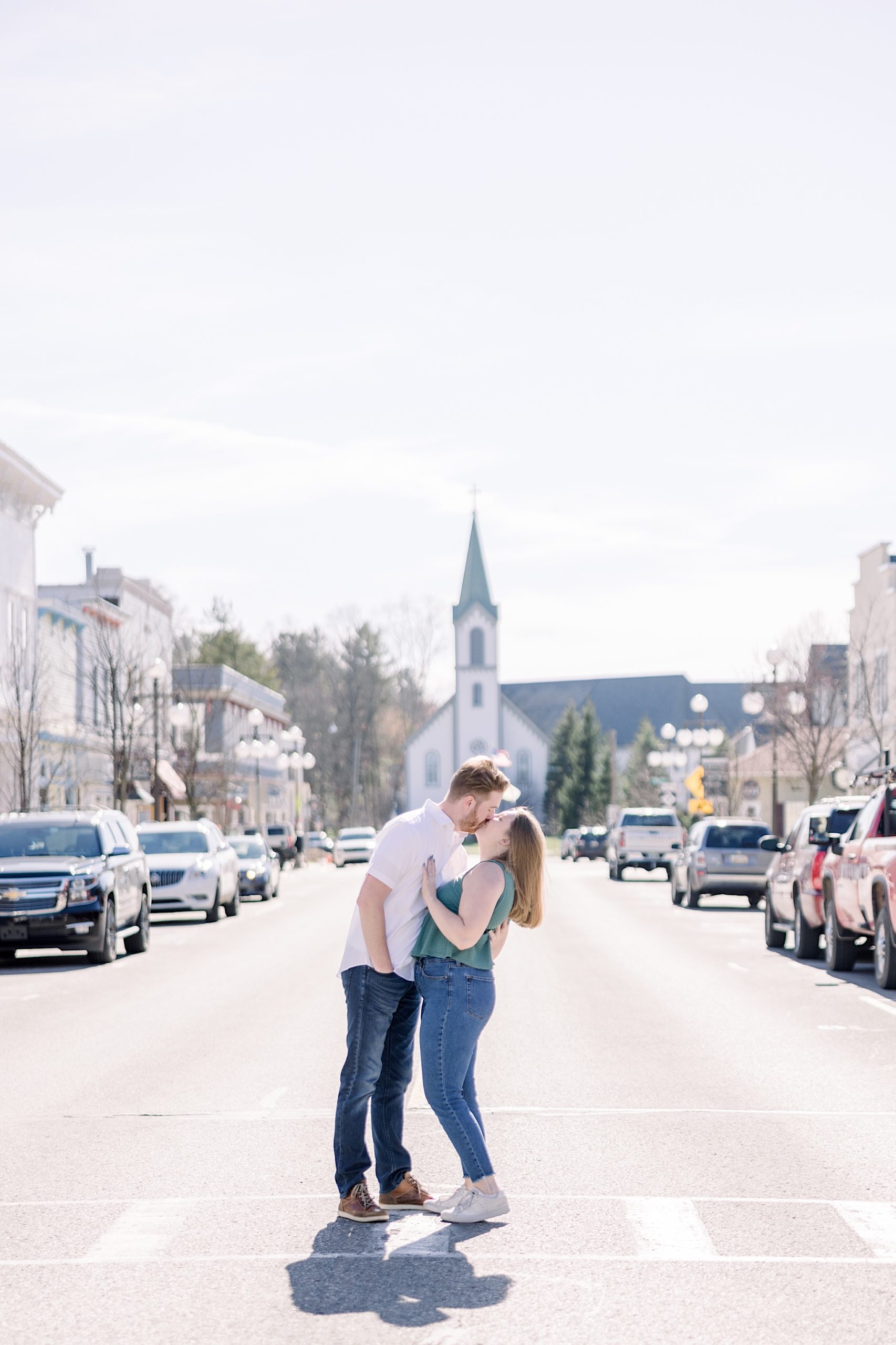 Couple kisses downtown during Harbor Springs Engagement session.
